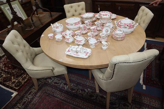 A Neptune light oak circular topped dining table and a set of four Neptune buttoned back dining chairs Table diameter 150cm